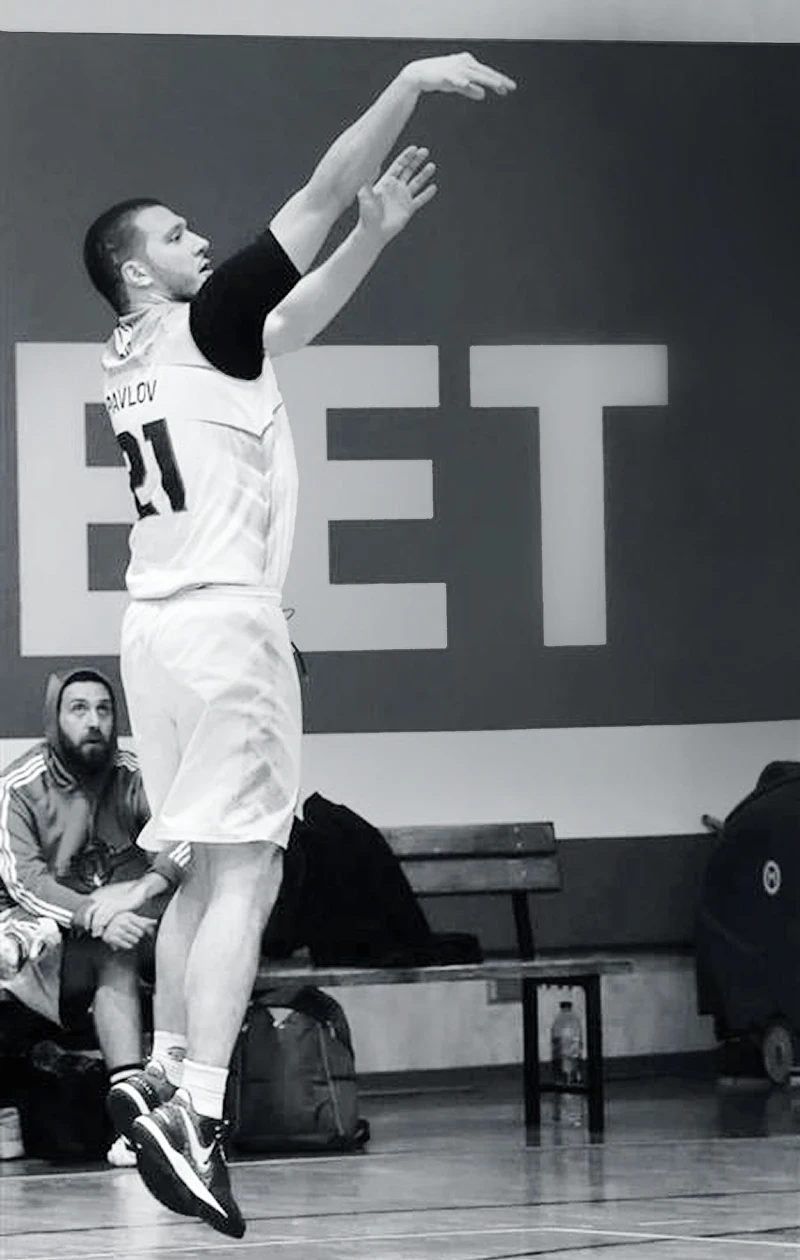 Yulian taking a jump shot on a basketball court