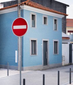 A blue house with a no-entry sign on its corner