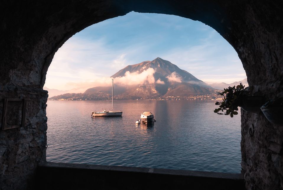A lake and a mountain framed by a stone arch