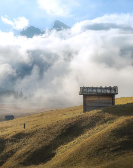 A hut on a hill above a sea of clouds